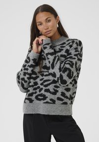 Gray knit sweater with black leopard print, high neckline, and ribbed hem. Soft texture, relaxed fit, and dropped shoulders.