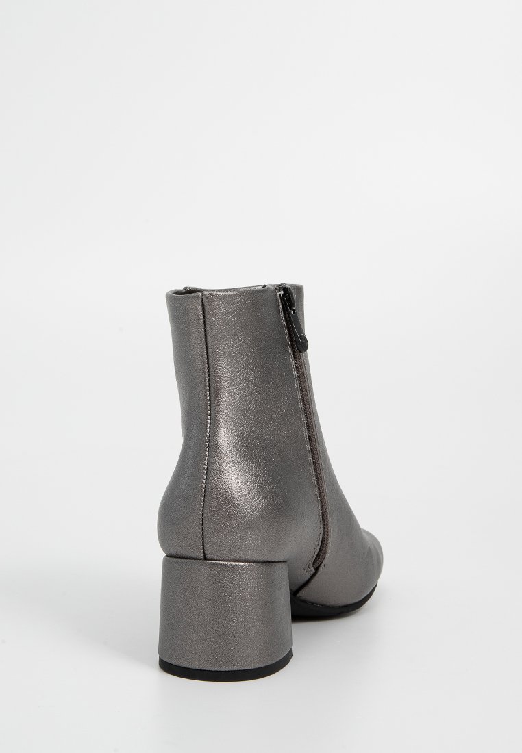 Stivaletto grigio metallico con tacco largo, texture liscia, zip laterale e design snello. Adatto per diverse occasioni.