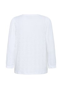 Haut blanc à manches longues avec un design en œillets, un col rond et des poignets froncés. Fabriqué en tissu léger avec une finition texturée.