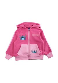 Sweat à capuche zippé rose en tissu doux, présentant des motifs du personnage Stitch sur la poitrine et les poches, avec des bandes accentuées blanches le long des manches.