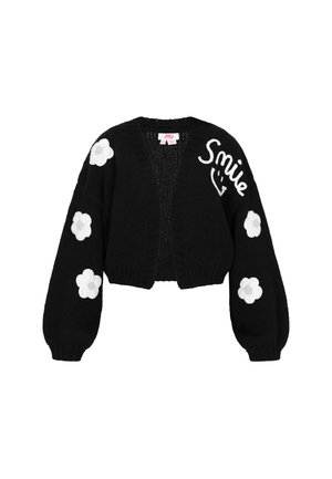 Cardigan noir en tricot avec un design court, des manches ballons, des appliqués de fleurs blanches sur les manches et le texte "Smile" brodé sur le devant.