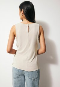 Next BOW DETAIL SLEEVELESS .  - REGULAR FIT - Top - ecru