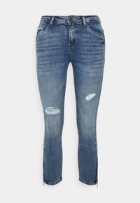 Jeans de ganga em azul médio com detalhes desgastados nos joelhos, ajuste slim, bainhas com fecho de correr, design de cinco bolsos e passantes para cinto.