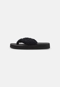 Black flip-flop with a textured fuzzy strap, flat rubber sole, and textured footbed, designed for comfort and casual wear.