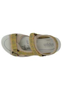 Beige sandal with yellow patterned straps, featuring adjustable closures and a cushioned footbed showcasing "made for me" text.