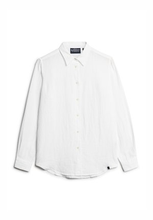 Camisa blanca de manga larga hecha de un tejido ligero. Presenta un cierre frontal con botones, collar clásico y dobladillo redondeado. Incluye una sutil marca en la etiqueta.