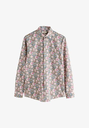 Bloemenprint lang shirt met lange mouwen op een lichtbruine achtergrond, met roze en blauwe bloemen, knoopsluiting aan de voorkant en standaardkraag.