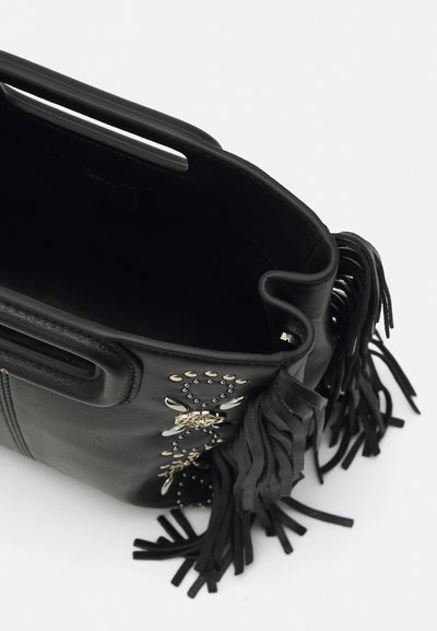 Black leather handbag with fringe detailing, metallic accents, and a zippered closure. Features an open interior and soft texture.