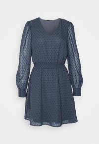 Navy blue dress made from sheer fabric featuring a polka dot texture, V-neckline, elastic waist, and long puff sleeves with cuff details.