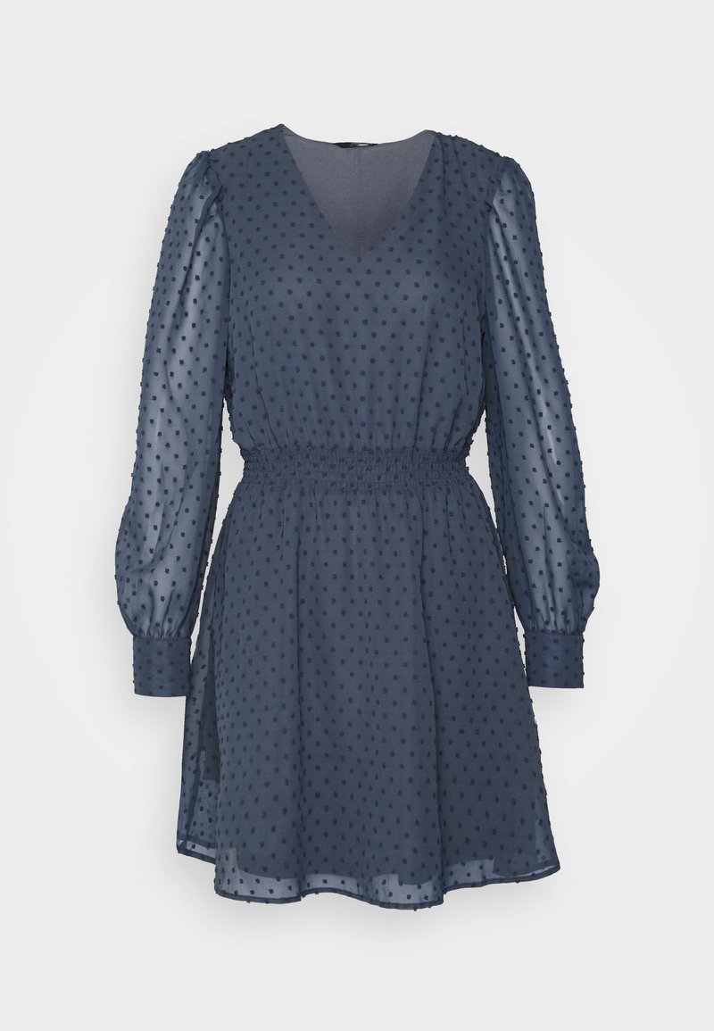 Navy blue dress made from sheer fabric featuring a polka dot texture, V-neckline, elastic waist, and long puff sleeves with cuff details.