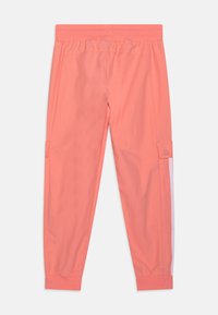 Korallenfarbene Cargo-Hosen aus leichtem Stoff, mit Seitentaschen und weißen Seitenstreifen. Elastischer Bund und gekräuselte Knöchel.
