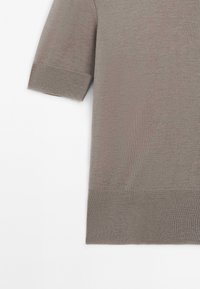 Sweter z krótkim rękawem w kolorze taupe, wykonany z dzianiny, z ściągaczami przy mankietach i dolnym końcu, leżący na białym tle.