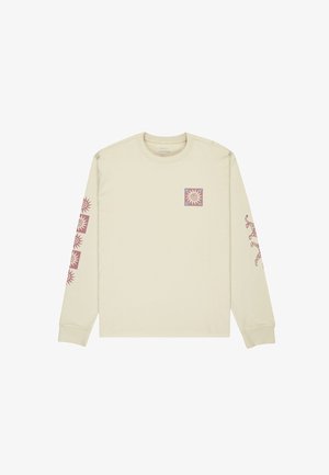 Camicia a maniche lunghe di colore beige chiaro, realizzata in cotone, con una grafica di un sole quadrato viola sul petto e motivi di sole ripetuti sulle maniche.