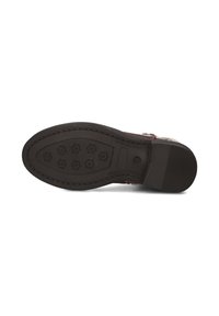 Semelle de chaussure en caoutchouc noir avec un motif texturé comportant des formes hexagonales et des rainures, conçue pour l'adhérence et la durabilité.