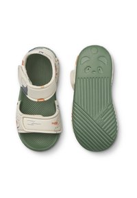 White and green children's sandals featuring adjustable straps, a textured sole, and colorful patterns of aquatic life on the upper.