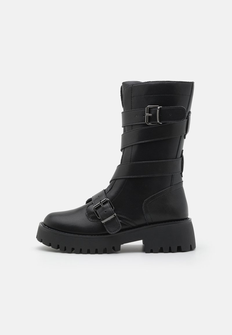 Black leather knee-high boot with buckle straps and textured sole. Rounded toe, sturdy heel, and visible stitching details.