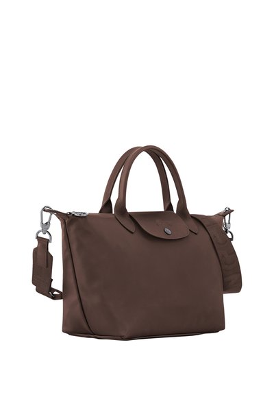 Brown tote bag with double handles, flap closure, and detachable shoulder strap, set against white background.