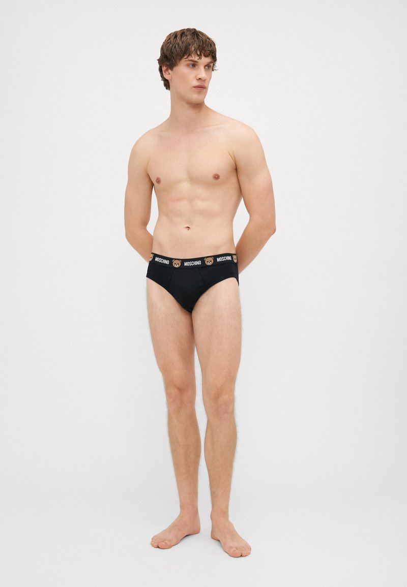 Moške črne bokserice iz bombaža, z kontrastnim logotipom na pasu z motivom medveda. Gladka tekstura in prilegnjena zasnova.