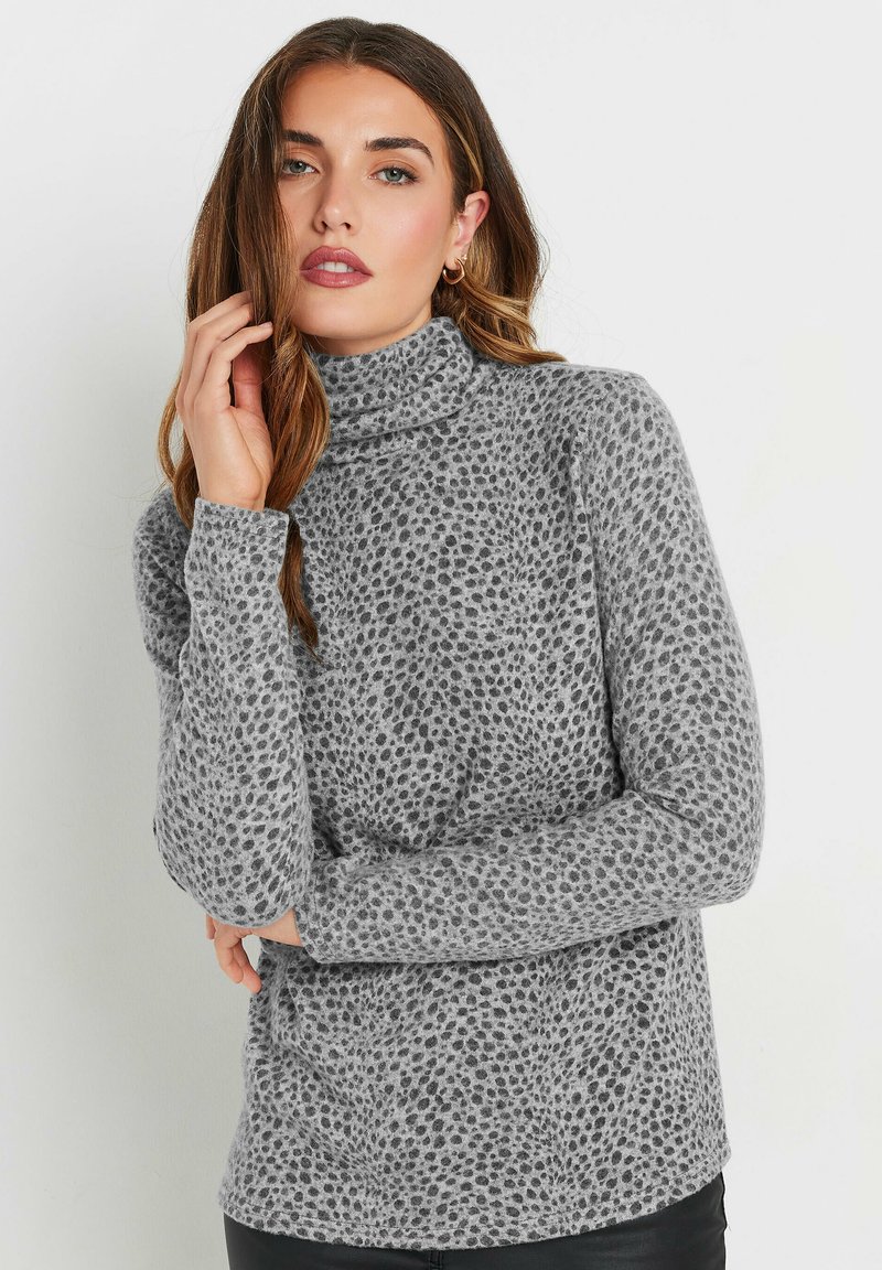 Maglione grigio a collo alto con un motivo testurizzato a pois, maniche lunghe e un tessuto morbido e accogliente.