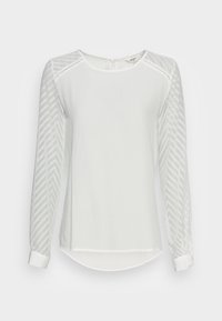 Haut blanc à manches longues avec des manches en maille texturée à motif chevron et un col rond, comprenant une ouverture en forme de clé dans le dos et un ourlet droit.
