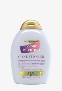 Hvit, perleaktig plastflaske med rund form, gull flip-top lokk og lilla tekst som fremhever "Balsam" og "Fargebevaring."