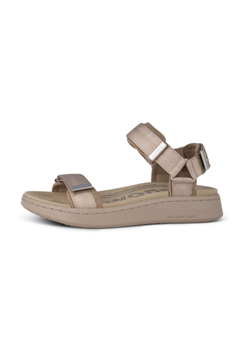 Light beige sandals with two adjustable fabric straps, silver hardware accents, and a cushioned sole labeled "NATURAL SOFT."