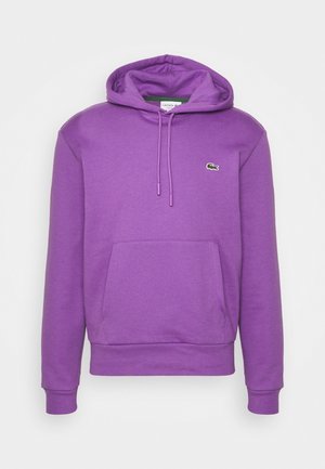 Sweat à capuche violet avec poche avant et cordons, avec un petit logo de crocodile vert sur la poitrine gauche.