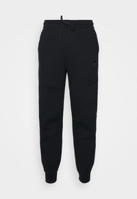 Pantaloni sportivi neri realizzati in misto cotone, con vita elastica e cordino. Tra le caratteristiche ci sono gambe affusolate e un discreto logo Nike.