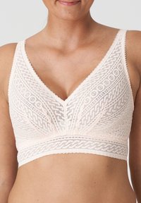 Lichtroze kanten bralette met een V-halslijn, voorzien van ingewikkelde geometrische patronen en een brede band. Zachte textuur met verstelbare bandjes.