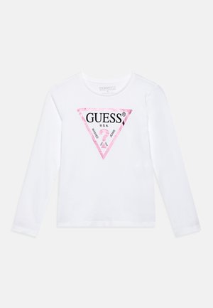 Hosszú ujjú, fehér pamut póló, amelyen egy rózsaszín, háromszög alakú logó található, középen "GUESS" és "U.S.A." felirattal. Sima textúra.