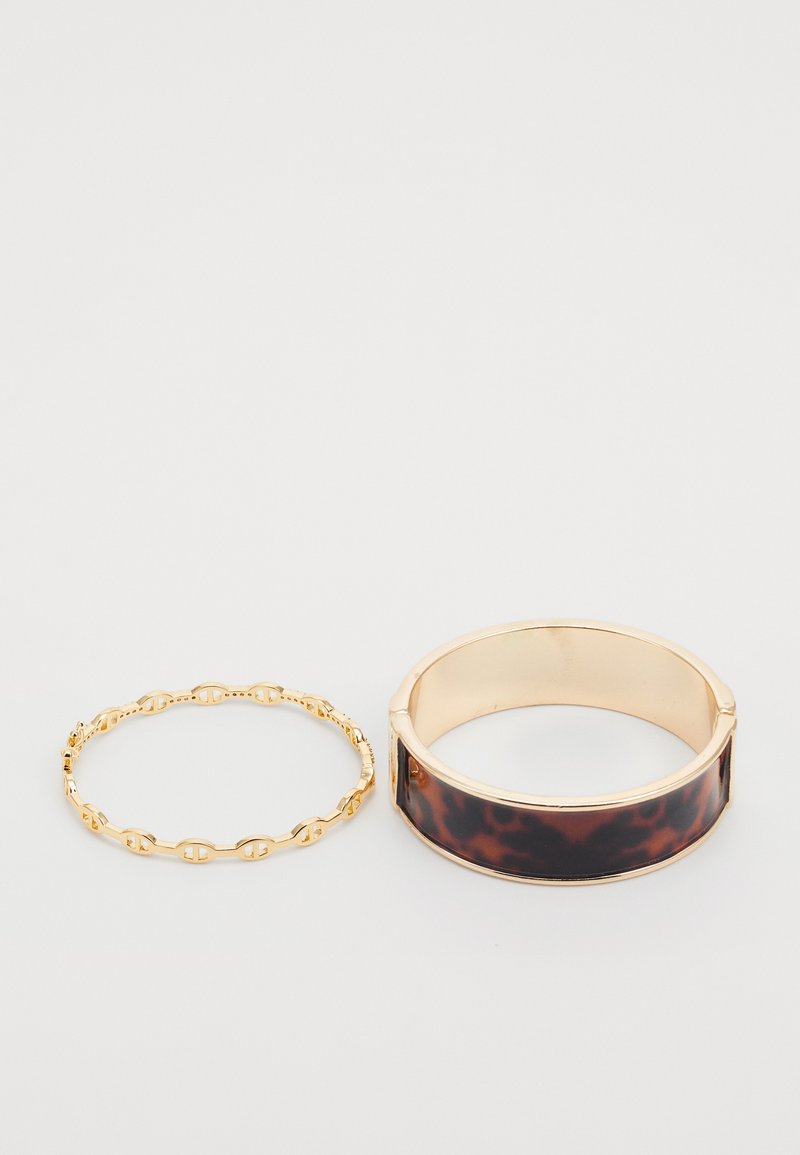 Gold-tone metal chain bracelet and wide bangle with a dark tortoiseshell pattern, featuring smooth textures and a sleek design.