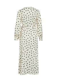 Robe midi crème à manches longues avec des pois noirs, taille cintrée par une ceinture, et ourlet évasé, vue de dos.