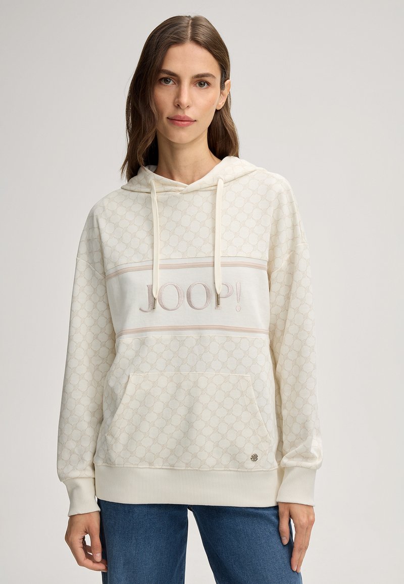 Haut à capuche couleur crème avec un motif texturé, poche frontale et capuche à cordon. Présente une bande horizontale beige avec le logo "JOOP!".