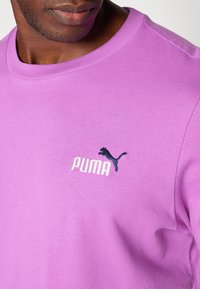 Lilafarvet t-shirt lavet af blød bomuld med rund hals. Har et lille marineblåt broderet Puma-logo og tekst på forsiden.