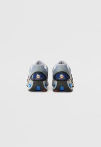 Running shoes with a grey mesh upper, blue accents, and a textured black sole. Features rounded heel and distinct logo details.