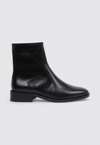 Botas de tobillo de cuero negro con un diseño elegante, punta afilada, textura suave y un tacón bajo apilado. Presentan un sutil detalle de costura.