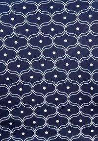 Marinblått tyg med ett dekorativt mönster av vita vågiga linjer och prickar, som skapar en upprepande geometrisk design. Slät textur.