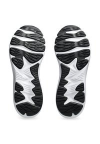 Semelles de chaussures de sport en noir et blanc présentant un motif de grip texturé et un design ondulé pour l'adhérence, fabriquées en caoutchouc et en matériaux en mousse.
