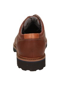 Scarpa in pelle marrone con finitura liscia, collare imbottito, fodera grigia e suola in gomma nera chunky con discreti dettagli a coste.