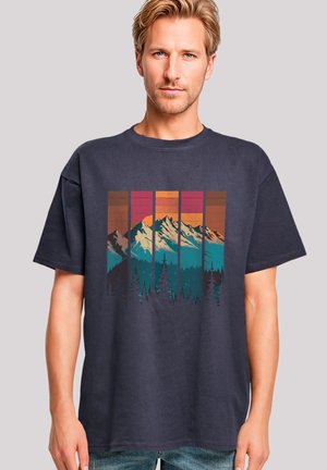 Navy cotton t-shirt featuring a mountain landscape graphic with peaks in white, surrounded by blue and orange stripes, displaying a sunset effect.