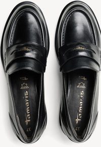 Schwarze Lederloafer mit runder Spitze, ausgestattet mit einem dekorativen Riemen und gesteppten Details. Glatte Textur und gepolsterte Innensohle.
