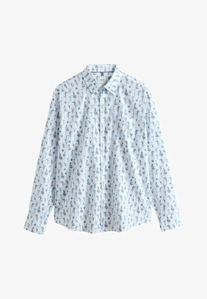 Camicia bianca a maniche lunghe con bottoni, decorata con un motivo floreale blu e nero, con taschino sul petto, disposta su uno sfondo bianco.
