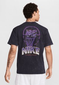 Nike basketball t-shirt in dark gray, featuring a large purple graphic of a basketball hoop and "72" on the back, with textured lettering.