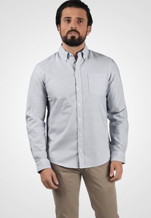 Stribet button-up skjorte i blå og hvid, lavet af bomuldsstof, lange ærmer, enkelt brystlomme, lige krave og bøjet kant.