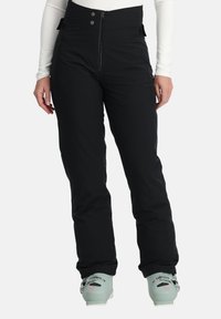 Zwarte skibroek met een hoge tailleband, een rits aan de voorkant en twee drukknoopjes. Heeft een gladde textuur en verstevigde onderbenen.