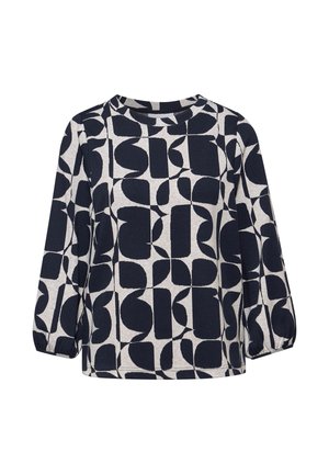 Camisa de manga larga con puños elásticos, con un patrón geométrico abstracto en blanco y negro sobre un fondo claro.