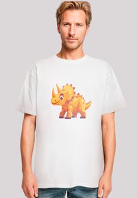 White cotton t-shirt featuring a colorful, cartoon-style dinosaur graphic in shades of orange and yellow at the center, with detailed accents.