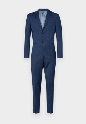 Tumed meresinine ülikond peene ruudumustriga, millel on kahe nupuga bleiser ja sirged püksid. Valmistatud tekstuurilisest kangast.