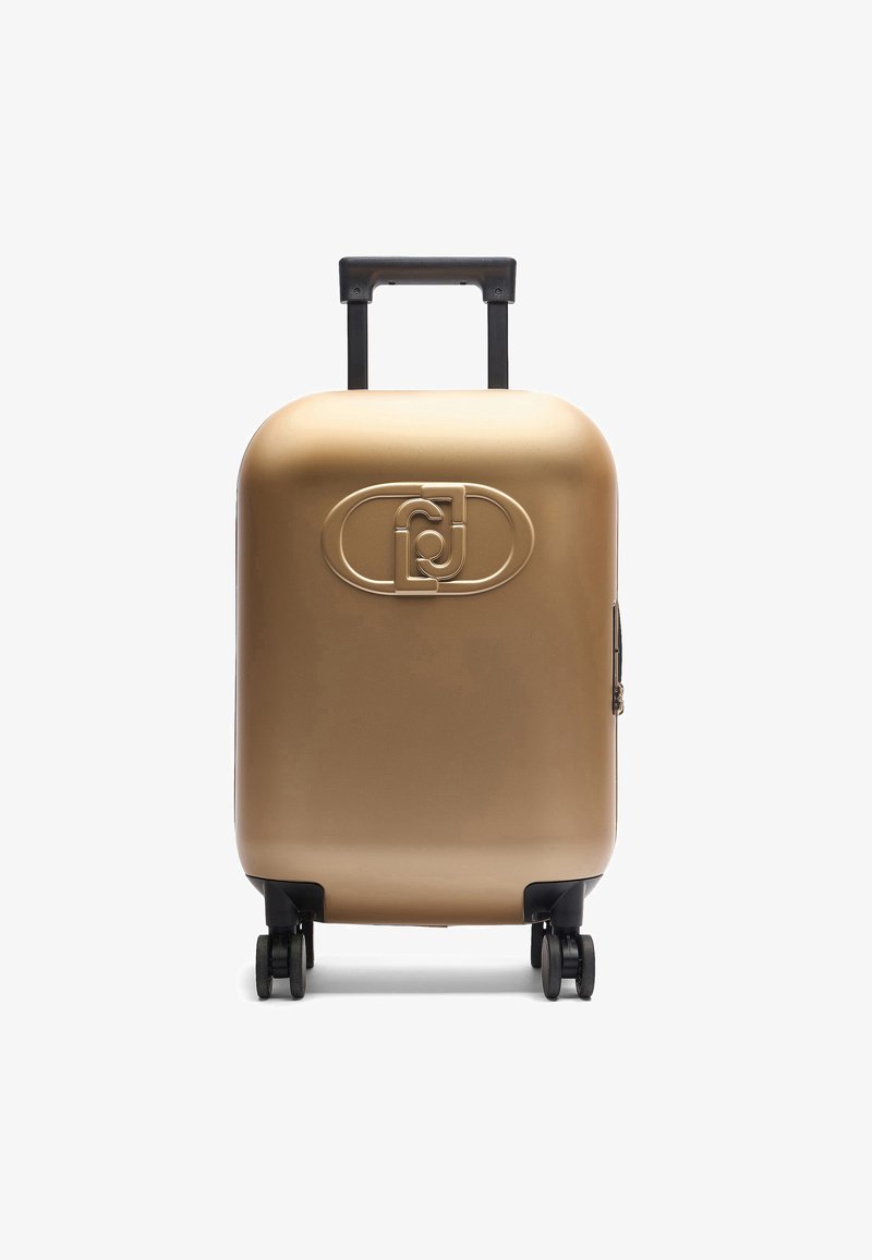 Valise rigide en or métallisé, dotée d'une surface lisse, d'un logo sculpté à l'avant, d'une poignée noire rétractable et de quatre roues noires.