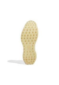 Semelle de chaussure avec une texture en caoutchouc jaune clair, présentant des clous de traction ronds et un détail de logo central, forme incurvée au niveau des orteils.